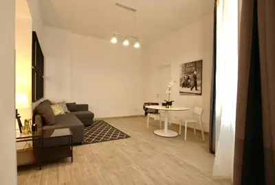 a living room with a couch and a table at Domus in Laterano in Rome