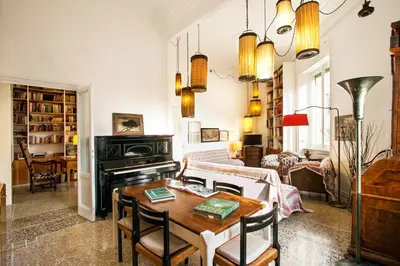 a living room with a table and a piano at Wanderlust - FromHometoRome in Rome