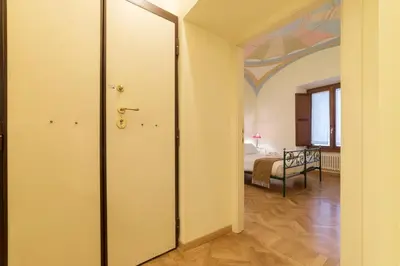 a hallway with a door leading to a bedroom at Casa Cornacchie - FromHometoRome in Rome