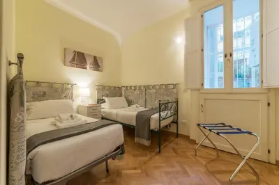 a bedroom with two beds and a window at Casa Cornacchie - FromHometoRome in Rome