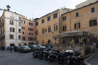a group of motorcycles parked in a street next to buildings at Casa Cornacchie - FromHometoRome in Rome