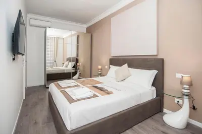 a bedroom with a large bed and a living room at Magia in Trastevere in Rome