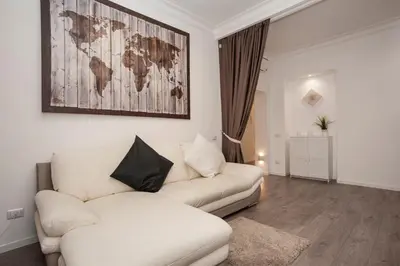 a living room with a couch and a map on the wall at Magia in Trastevere in Rome