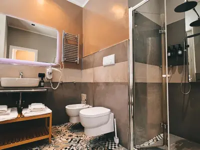a bathroom with a toilet and a sink and a shower at Fabio Massimo Guest House in Rome