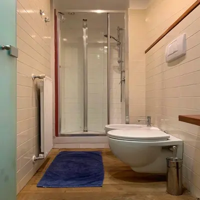 a bathroom with a tub and a toilet and a shower at Sforza Apartment in Rome