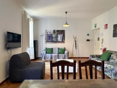 a living room with a couch and a table and chairs at Vatican Charming Suite in Rome