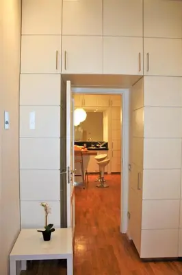 a living room with white cabinets and a table at Navona Secret Suite in Rome