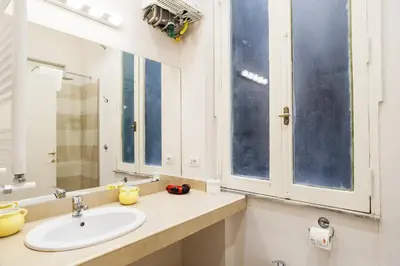 a bathroom with a sink and a mirror at Vicolo Torretta - FromHometoRome in Rome