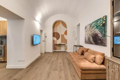 a living room with a couch and a painting on the wall at Casa Alessandra in Rome