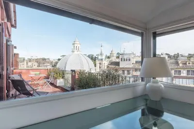 a window with a view of a city skyline at Paradiso Penthouse - FromHometoRome in Rome