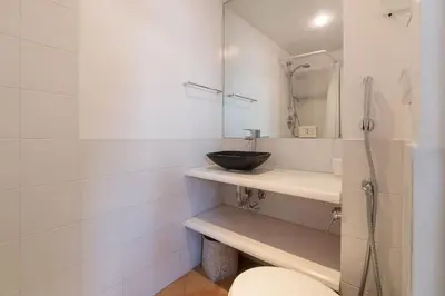 a bathroom with a sink and a toilet at Paradiso Penthouse - FromHometoRome in Rome