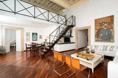 a living room with a spiral staircase in the middle at Your Home at Campo de' Fiori in Rome
