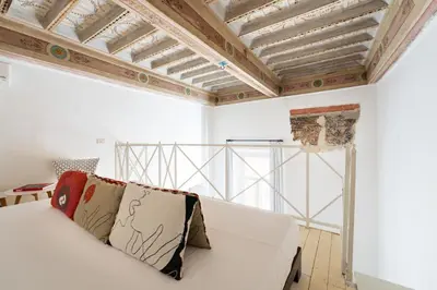 a white couch in a room with a ceiling at Your Home at Campo de' Fiori in Rome