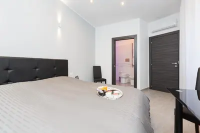 a bedroom with a bed with a plate of food on it at Domus Arena in Rome