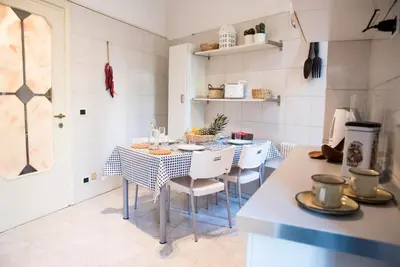 a kitchen with a table and chairs in a room at Porta Latina Apartment in Rome
