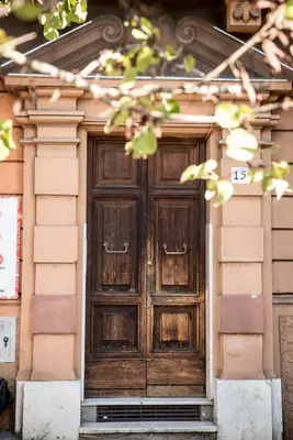 a wooden door on the side of a building at Porta Latina Apartment in Rome