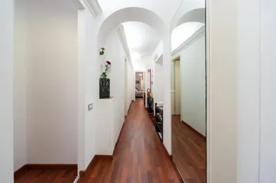 a hallway of a house with white walls and wood floors at Monticello apartment via Cavour in Rome