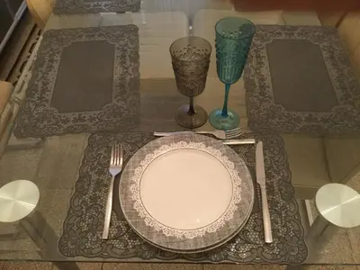 a table with a plate and two glasses and a fork at A casa di Fiamma in Rome