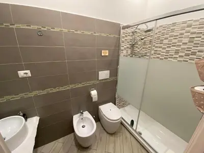 a bathroom with a toilet and a sink and a shower at Sweet Sleep Vatican in Rome