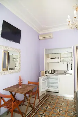 a dining room with a table and chairs and a mirror at Sweet Sleep Vatican in Rome