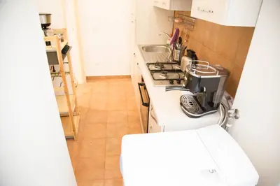 a kitchen with a sink and a stove top oven at Sweet Sleep Vatican in Rome