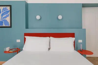 a bedroom with a bed with a blue headboard at Passepartout in Rome