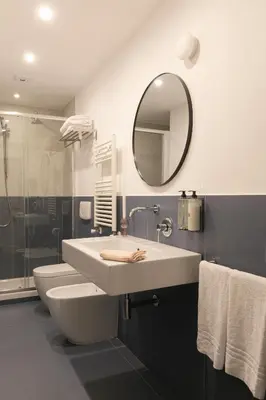 a bathroom with a sink and a toilet and a mirror at Passepartout in Rome