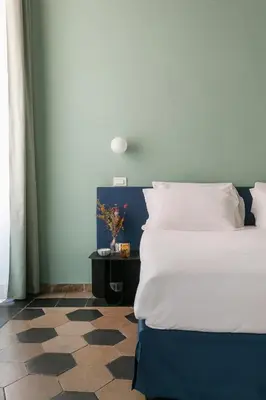 a bedroom with a bed and a table with a vase on it at Passepartout in Rome