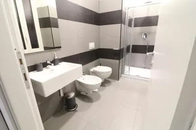 a bathroom with a sink and a toilet and a shower at CinqueSogni Guest House in Rome