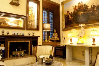a living room with a fireplace and a painting on the wall at Guesthouse Borromeo Roma in Rome