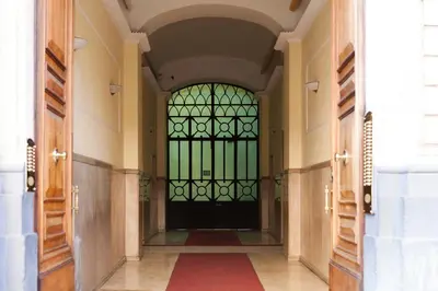 a hallway with a door with a red rug at Margherita Suites in Rome