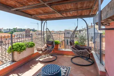 two chairs on a balcony with a view of a city at Il Nascondiglio del Prete in Rome