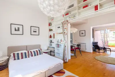 a bedroom with a bed and a living room at Il Nascondiglio del Prete in Rome