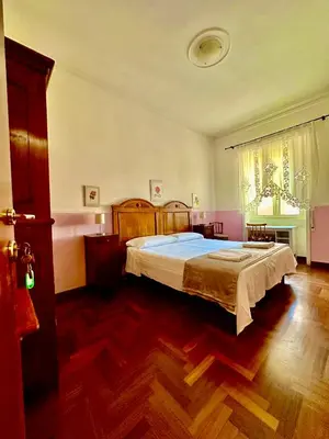 a bedroom with a large bed in a room at Pardis Guest house in Rome