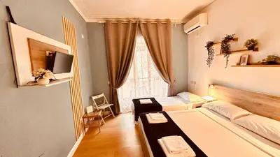 a small room with two beds and a window at Pardis Guest house in Rome