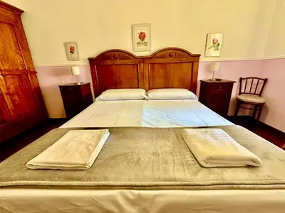 a large bed in a bedroom with two pillows on it at Pardis Guest house in Rome