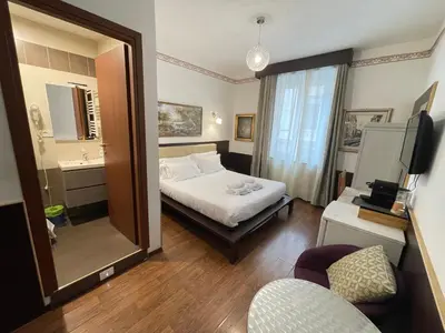 a hotel room with a bed and a mirror at Gold House in Rome