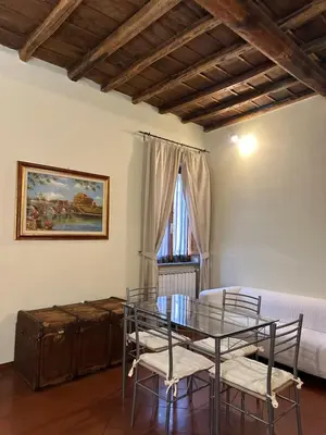 a dining room with a glass table and chairs at Navona Apartment Livia in Rome