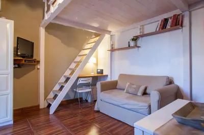 a living room with a couch and a staircase at Brancaleone86 - The Loft in Rome