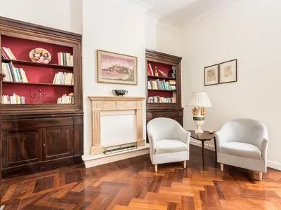 a living room with two chairs and a fireplace at Apartment Silla by Interhome in Rome