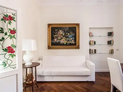 a living room with a white couch and a painting on the wall at Apartment Silla by Interhome in Rome