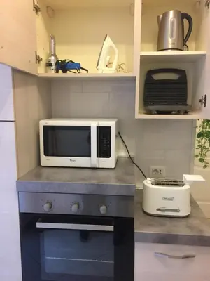 a microwave sitting on top of a counter in a kitchen at La Primavera Holidayhouse BEST LOCATION FOR VISIT THE VATICAN in Rome