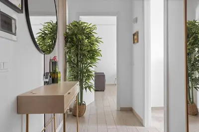 a hallway with potted plants and a table at Sapienza Apartment by RHR in Rome