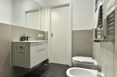 a bathroom with a white toilet and a sink at Campo de' Fiori Brand New Apartment in Rome