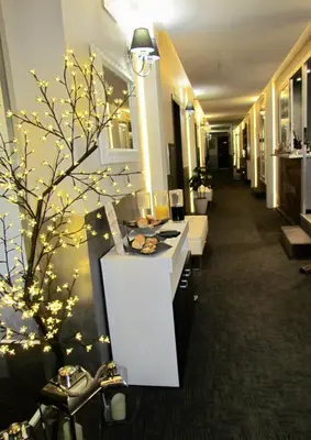 a hotel lobby with a christmas tree with lights at Brunelleschi Holidays Hostel in Rome