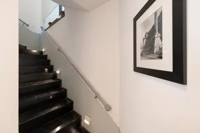 a staircase with a picture on the wall at Margutta Mews in Rome