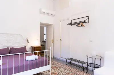 a living room with a bed and a table at B&B Domus Aurea in Rome