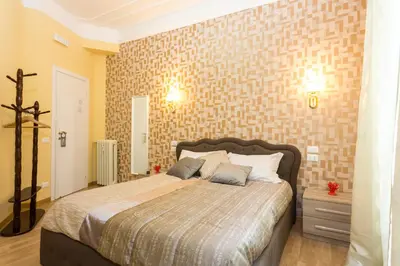 a bedroom with a bed and a brick wall at BQ House Castello Luxury Rooms in Rome