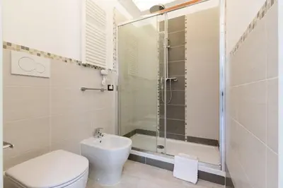a bathroom with a shower and a toilet and a sink at Casa Vacanze Colosseum by Serena in Rome