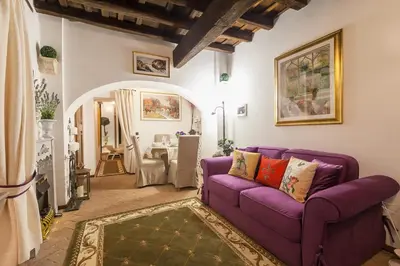 a living room with a purple couch and a table at M Empire in Rome